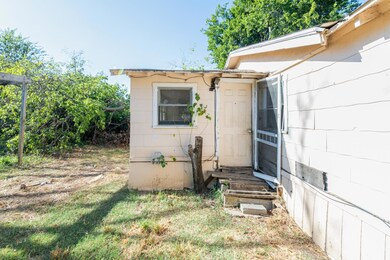 View of exterior entry featuring a lawn