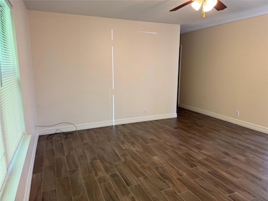 Unfurnished bedroom with dark wood finished floor