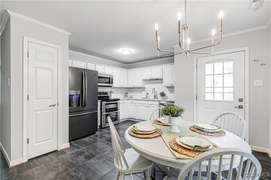 Tiled dining area with sink and crown molding