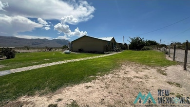 View of side of property with a lawn and a mountain view