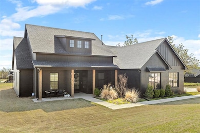 Rear view of property with board and batten siding