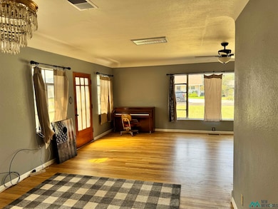 Unfurnished living room with a textured wall and light wood-style floors