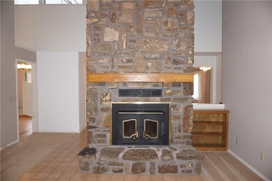 Wood burning fireplace in this massive native rock