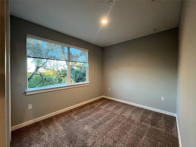 Unfurnished room featuring dark carpet and recessed lighting