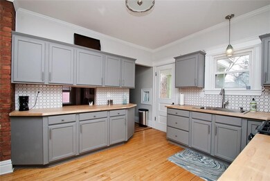 The updated kitchen in on-trend gray with tile bac