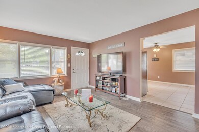 Living room toward front and kitchen