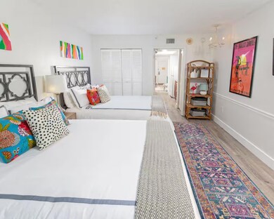 Bedroom with light wood finished floors and baseboards