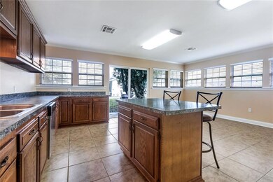 Kitchen features tons of windows, natural light an