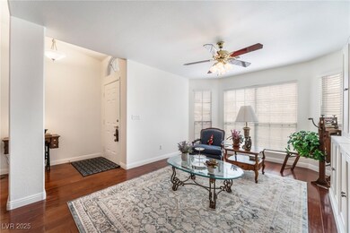 Living area featuring baseboards, dark wood-style