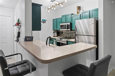Kitchen featuring kitchen peninsula, decorative ba