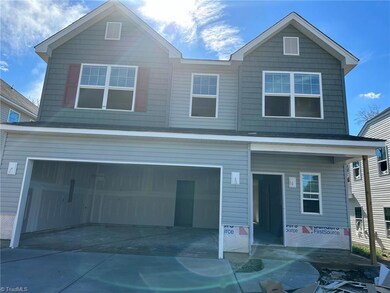 Stone wainscot to be installed, garage door with windows & decorative hardware 