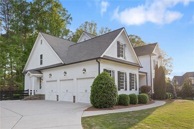 View of side of home featuring concrete driveway, a garage, a shingled roof, and a lawn