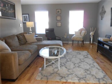 SPACIOUS LIVING ROOM WITH UPDATED HARDWOOD
