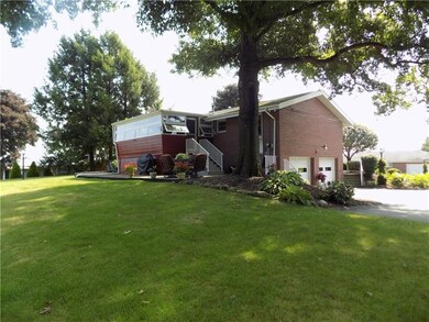 Large yard with mature shade trees and perennials.