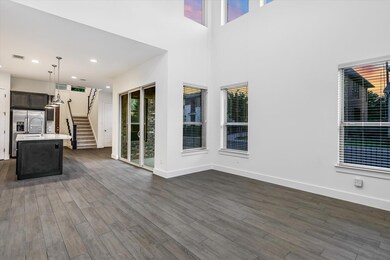 Unfurnished living room with stairs, dark wood-ty