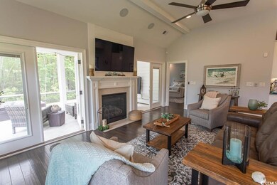 Living area with ceiling fan, wood-type flooring, 