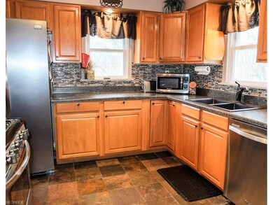 Updated kitchen with slate flooring and glass tile