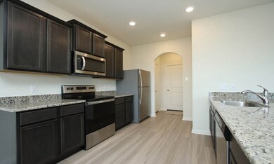 Large open kitchen that boasts granite counters, stainless steel appliances, and pantry