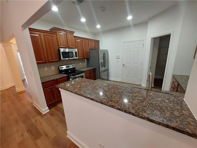 Kitchen featuring stainless steel appliances, a si