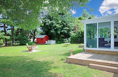 rear yard view with sunroom exterior to the right