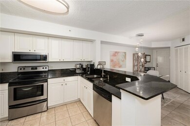 Kitchen with stainless steel appliances, white cab