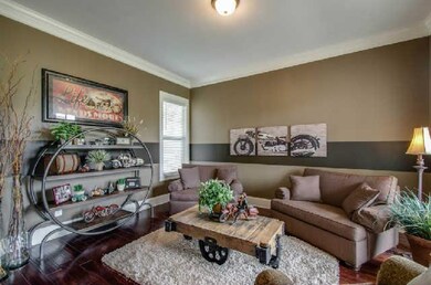 Formal living room with hardwood flooring. 