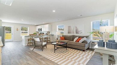 Living room with light hardwood / wood-style floor