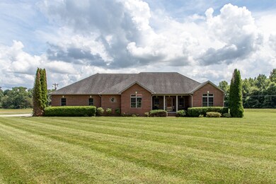 This country estate features a full brick one level custom home with an attached two bay garage plus another separate attached one bay garage/workshop                . 