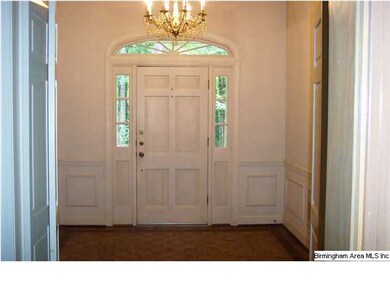 Foyer with beautiful crown mouldings, wood floorin