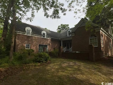 Rear view of house with brick siding