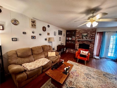 Living room featuring wood finished floors, built