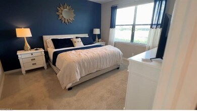 Bedroom with light colored carpet and baseboards