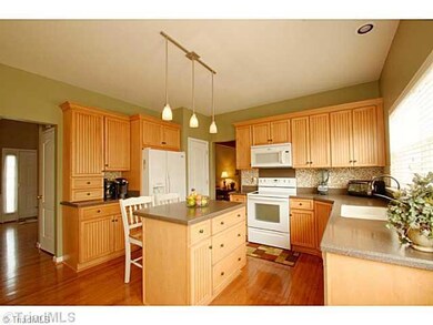 Kitchen. Light, bright and airy! Upgraded cabinets, glass tile...a great layout for the family chef!