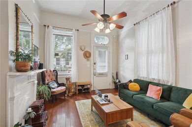 Window light, mantel and wood floors add to the ch