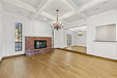 Living room featuring coffered ceiling, an elegant