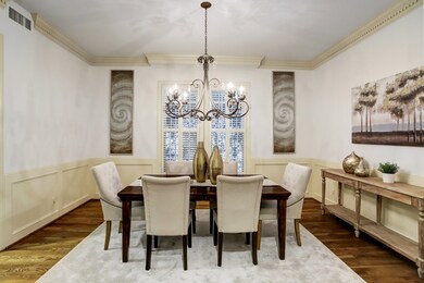 This formal dining room features wood flooring, cr