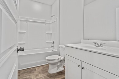 Full bathroom featuring hardwood / wood-style floo