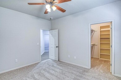 Unfurnished bedroom with a spacious closet, carpet