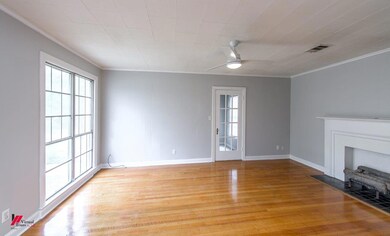 Unfurnished living room with crown molding, ceilin