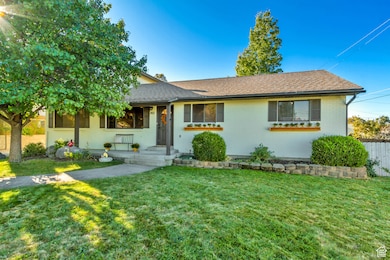 Ranch-style home featuring a shingled roof and brick siding