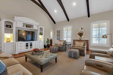 Living room featuring beamed ceiling, high vaulted
