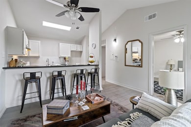 Living room with sink, light tile patterned floors