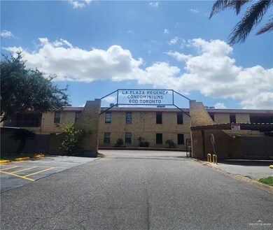 View of property featuring uncovered parking