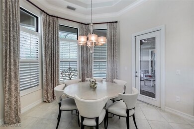 Dining area with a chandelier, light tile patterne