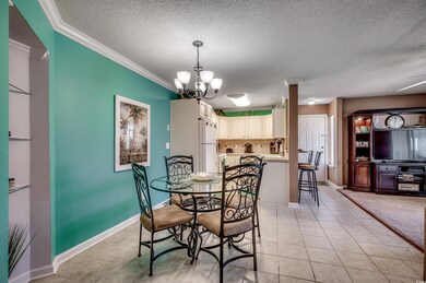 Dining area featuring crown molding, light tile pa