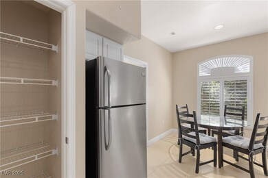 Dining room with light tile patterned flooring and recessed lighting