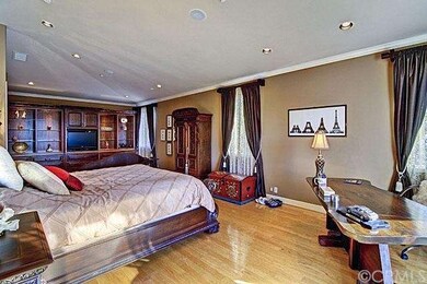 Master Suite - Custom media niche in retreat area, recessed lighting, private balcony with retractable awning, crown moldings.