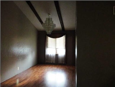View of the dining room. Faces West. Big chandelie
