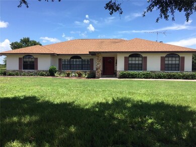 Green pastures surround this ranch home with a sid