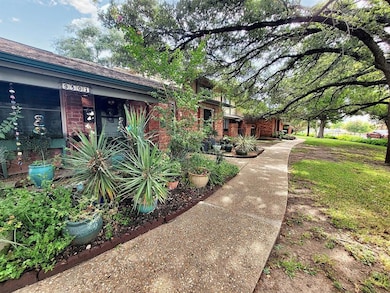 View of property exterior featuring brick siding and a shingled roof